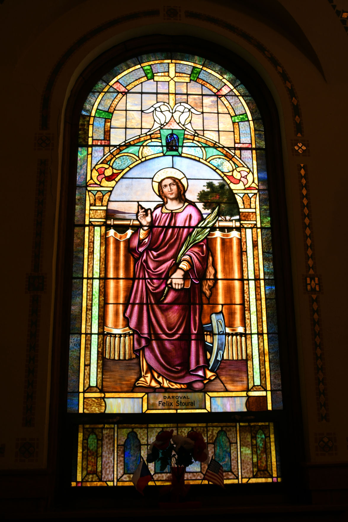 138 The stained glass windows depict pictures of saints important to the church.JPG